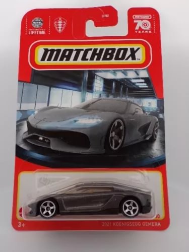 Charcoal gray diecast sports car in Matchbox blister package, front view