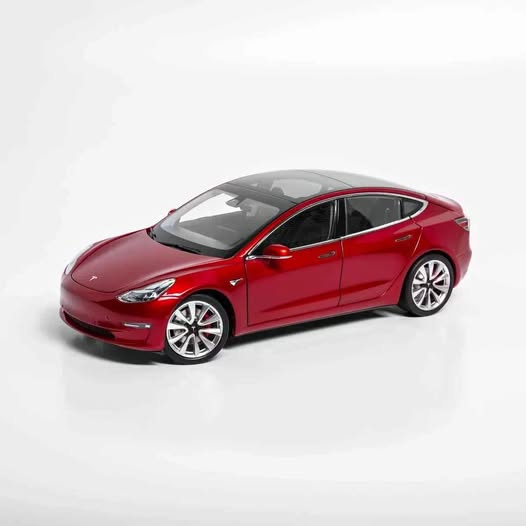 1:18 diecast Tesla Model 3 sedan, red with white wheels, front three-quarter view