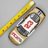 Gold and white NASCAR diecast race car with number 23, front view, sponsor decals