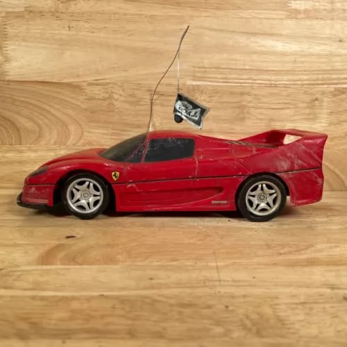 Red 1:18 diecast sports car toy for parts, damaged body and rear wing
