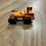 Orange metal diecast mini truck tractor with black wheels, side view