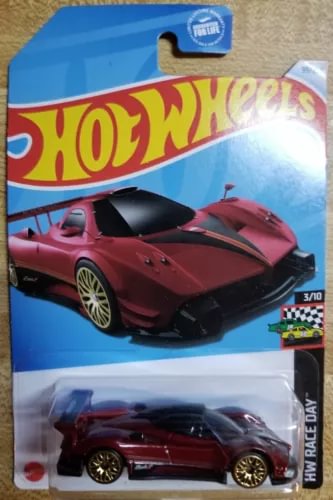 Hot Wheels red diecast race car in retail blister, black rear wing and wheels