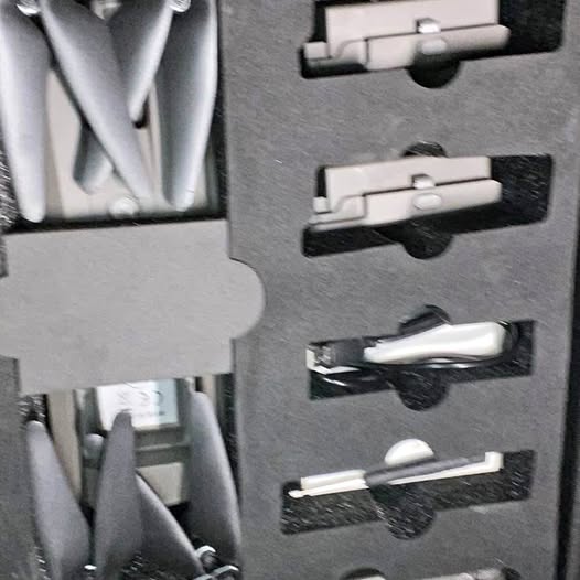 Drone parts and accessories in gray foam insert with molded compartments
