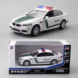 Police car diecast scale model toy in box, white with green stripe and red/blue light bar