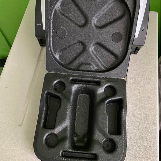 Hard drone case interior with molded black foam compartments and latch cutout