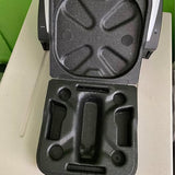 Hard drone case interior with molded black foam compartments and latch cutout