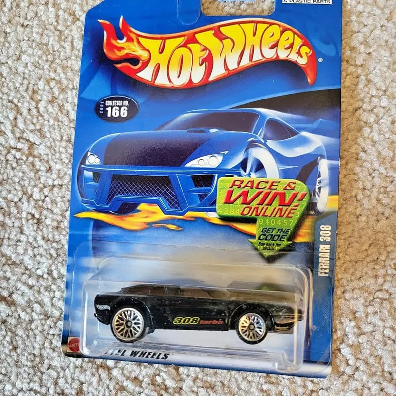 Hot Wheels diecast Ferrari 308 race car, black with gold wheels on card