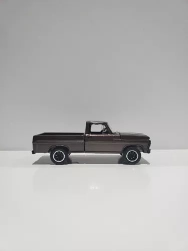 1:64 scale diecast pickup truck with open hood, dark gray finish and black wheels