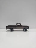 1:64 scale diecast pickup truck with open hood, dark gray finish and black wheels