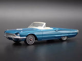 Blue 1966 Ford Thunderbird convertible diecast model car, side view, 1:64 scale