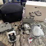 DJI Mini 2 drone and accessories set with controller, cables, and carrying bag