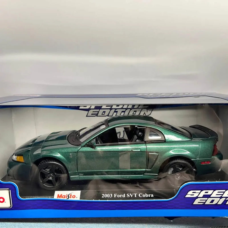 Green and black 2003 Ford SVT Cobra diecast car model, side view in display box