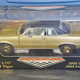 1965 Pontiac GTO diecast model car, gold with black wheels, side view