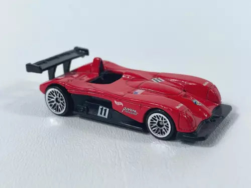 Red Hot Wheels diecast race car model with black rear wing, 1/64 scale