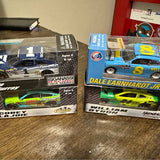 Boxed diecast race cars with blue and green models on packaging, age 4+
