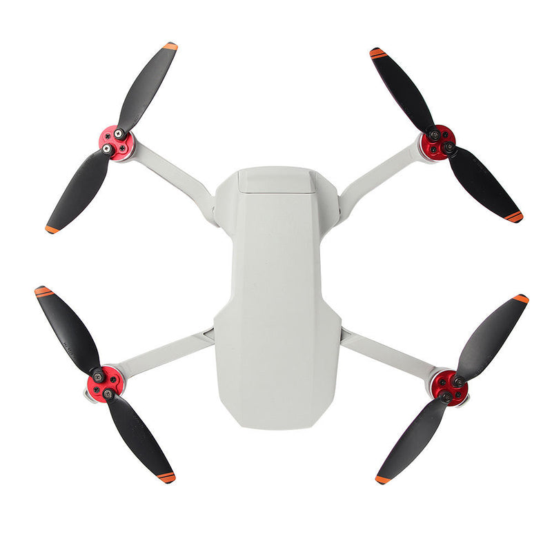Drone motor protector guard caps with red mounts; white drone body and four propellers