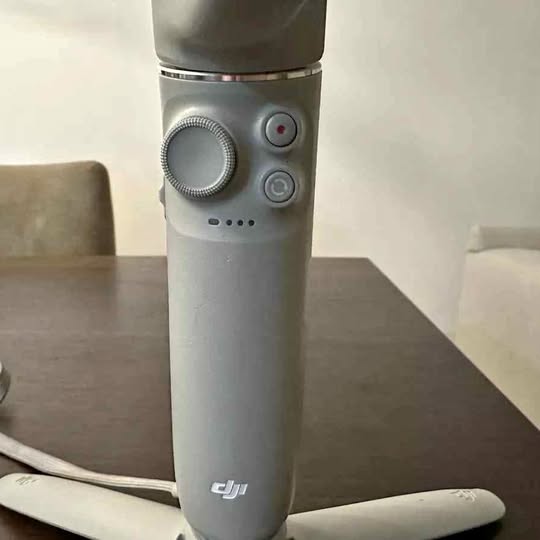 DJI gimbal handle with thumb dial and side buttons, gray