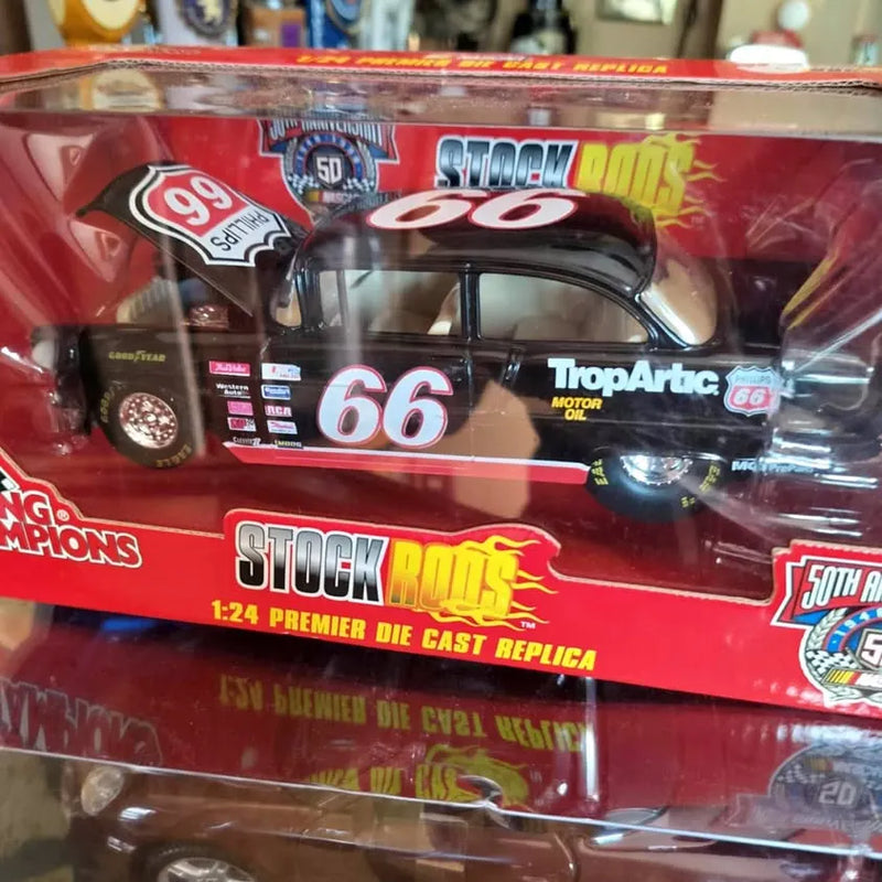Diecast stock car model in clear box, black car with number 66 graphics