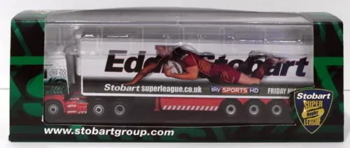 Diecast model truck in clear display case, green and dark livery with racing sponsor graphics