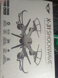 Quadcopter drone in retail box, gray propeller arms, X-31 Shockwave branding