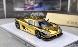 Electroplated gold racing diecast model car with black wheels, front three-quarter view