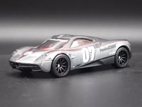1/64 diecast model car in silver with racing stripes, black wheels, number 01 on hood.