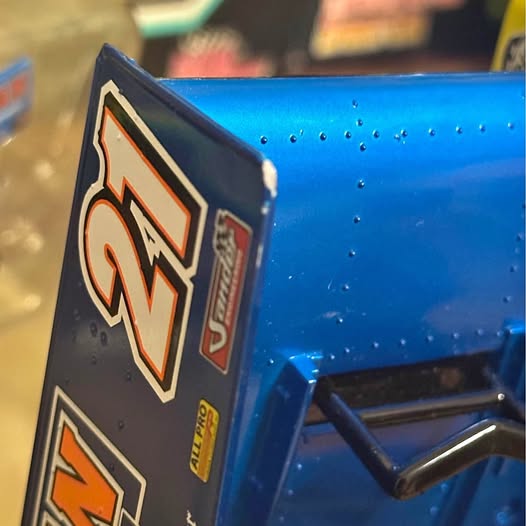 Blue diecast ship model with logo decal and small side details