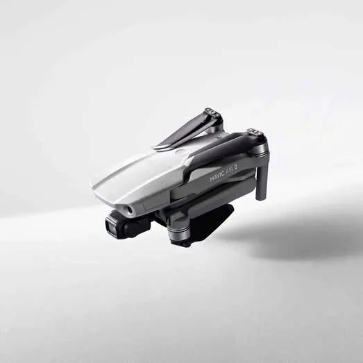 Foldable quadcopter drone, gray and black with visible propellers and camera