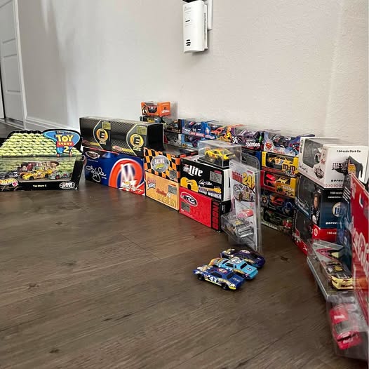 Hot Wheels diecast model car collection with boxed cars and loose cars on display