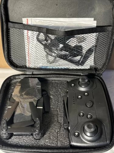 Foldable RC quadcopter drone and remote controller in black storage case