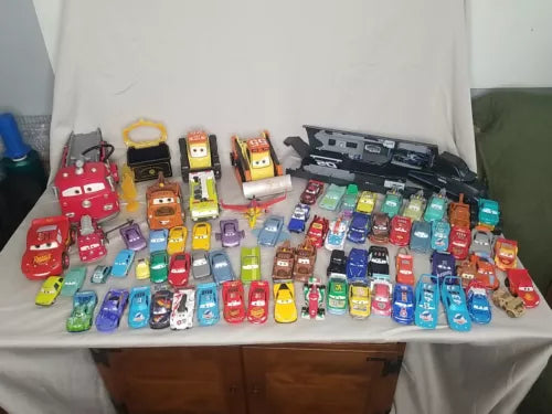 Toy diecast car lot with multiple small character vehicles in assorted colors