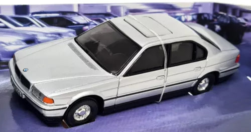 Silver diecast model car, front-left view, classic 2-door sedan.