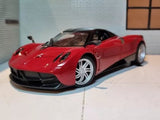 Red 1:24 diecast supercar model with black front splitter and silver spoke wheels