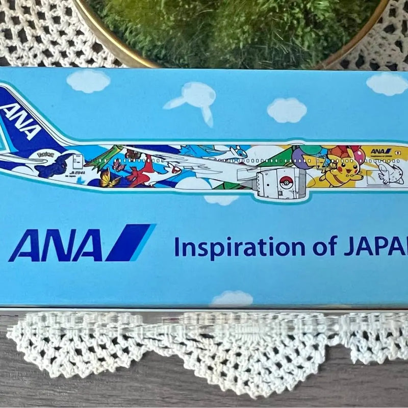 Blue ANA 787-900 diecast model airplane with cartoon characters along the fuselage