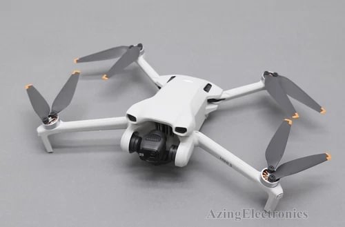 White quadcopter camera drone with front gimbal and four folding propellers