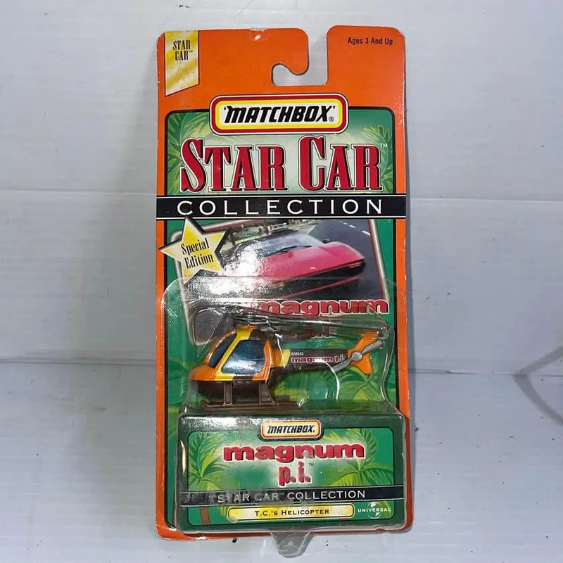 Die-cast helicopter toy in blister pack, orange and green, Matchbox Star Car Collection.