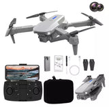 White foldable quadcopter drone with controller and spare accessories, compact travel set