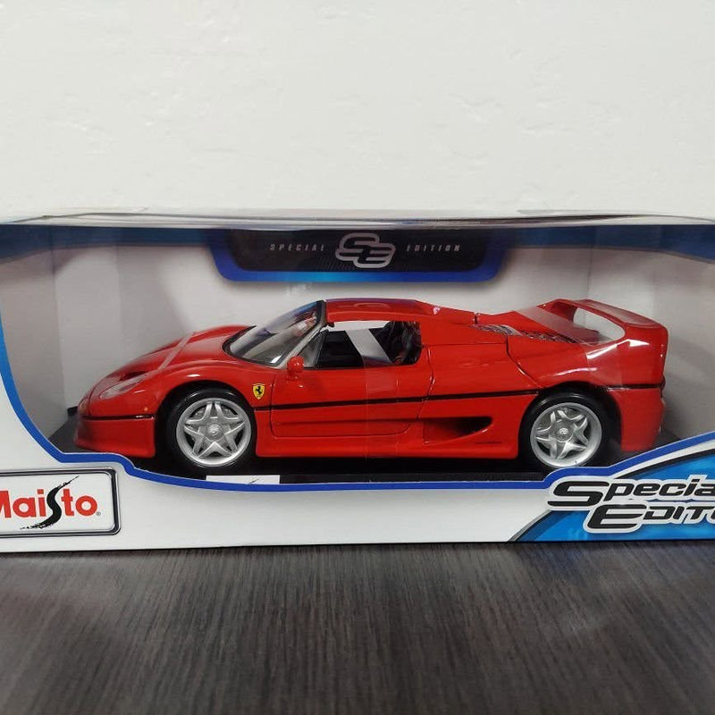 Ferrari F50 diecast 1:18 model sports car, red with silver wheels and black roof.