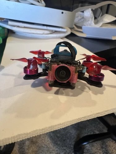 Quadcopter drone with front camera and four red propellers
