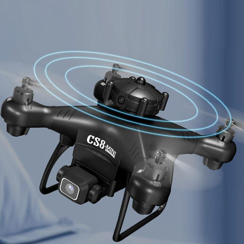 Quadcopter drone with front camera module, black and gray body, propeller arms