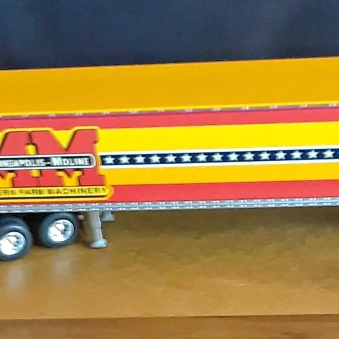 Yellow diecast semi truck trailer with star stripe panel and red logo