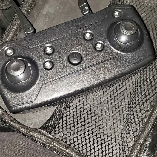 Black drone remote controller with dual thumbsticks and buttons