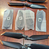 Set of matte black drone propellers and protective packaging bags
