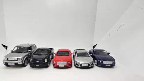 Diecast toy car collection with five front-facing model cars in dark and red