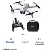 Folding drone with four propellers, controller, and black carry case