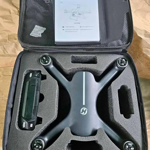Compact black drone with camera and propeller mounts in carrying case