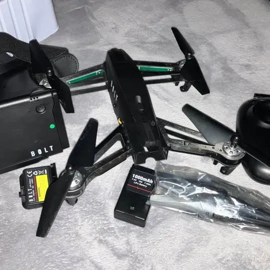 Black quadcopter drone with four propellers, drone body, and battery pack