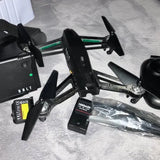 Black quadcopter drone with four propellers, drone body, and battery pack