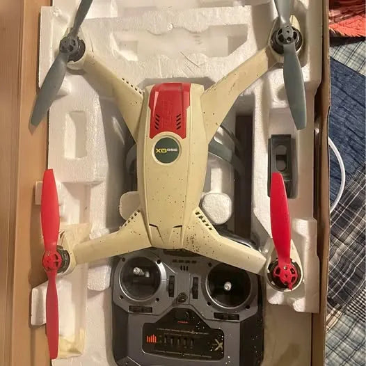 Beige 350QX drone with red propellers and dual cameras, in protective foam insert