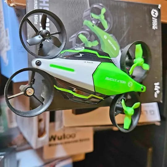 Kids drone with green and black body, four propellers, and front camera housing